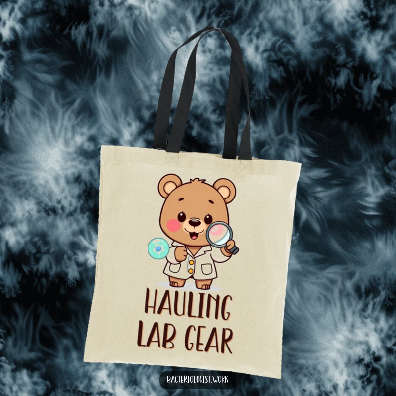 Funny scientist bear in a lab coat, happily examining a tiny cell with a magnifying glass, a practical and amusing tote.